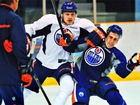 U.S. college defenceman Joey Laleggia, right, gets knocked down by first-round draft pick Leon Draisaitl during the Edmonton Oilers’ annual prospect development camp at Jasper on July 3, 2014.