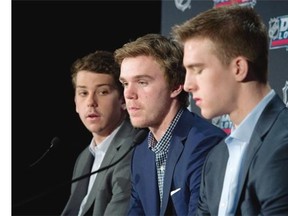 Connor McDavid, centre, speaks to reporters with fellow potential draftees Dylan Strome, left, and Noah Hanifin following the announcement of the NHL Draft Lottery in Toronto on Saturday, April 18, 2015. The Edmonton Oilers have won the NHL draft lottery and the right to select Connor McDavid first overall. THE CANADIAN PRESS/Darren Calabrese