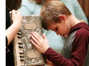 Connor Wild, 11, checks out an accordian at a musical instrument “petting zoo” held at the Winspear Centre. Canadian National Institute for the Blind child clients went backstage at the Winspear Centre for a hands-on exploration of musical instruments on March 8, 2015.