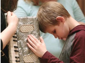 Connor Wild, 11, checks out an accordian at a musical instrument “petting zoo” held at the Winspear Centre. Canadian National Institute for the Blind child clients went backstage at the Winspear Centre for a hands-on exploration of musical instruments on Sunday March 8, 2015.