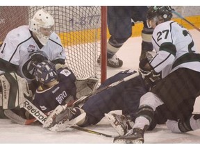 Crusaders goalie Tommy makes a save with Brandon Biro crashing the net in the AJHL North Division semifinal Game 4 between the Sherwood Park Crusaders and the Spruce Grove Saints at the Sherwood Park Arena, March 17, 2015.