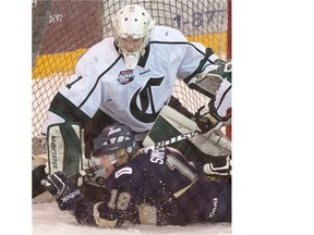 Crusaders goalie Tommy Nixon makes a save with Riley Simpson in the AJHL North Division semifinal Game 4 between the Sherwood Park Crusaders and the Spruce Grove Saints at the Sherwood Park Arena, March 17, 2015.