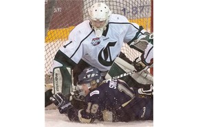 Crusaders goalie Tommy Nixon makes a save with Riley Simpson in the AJHL North Division semifinal Game 4 between the Sherwood Park Crusaders and the Spruce Grove Saints at the Sherwood Park Arena, March 17, 2015.