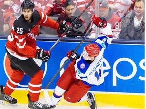 Darnell Nurse of Canada, left, places a hit on Pavel Buchnevich of Russia during the gold medal game of the 2015 IIHF World Junior Championship on Jan. 5, 2015 at the Air Canada Centre in Toronto.