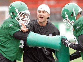 Defensive line coach Mike Scheper works with a couple of Saskatchewan Roughriders prospects during rookie camp at Mosaic Stadium in Regina on June 03, 2010.