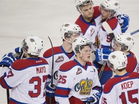 Dejected Edmonton Oil Kings hug after loosing in double overtime to the Brandon Wheat Kings in the first round of the WHL playoff series on April 1, 2015 in Edmonton.