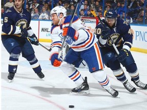 Derek Roy #8 of the Edmonton Oilers reacts after being clipped in the face by the stick of Maxim Lapierre #40 of the St. Louis Blues at the Scottrade Center on Jan. 13, 2015, in St. Louis.