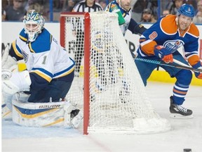 Derek Roy (8) of the Edmonton Oilers, tries to get to a loose puck beside goalie Brian Elliott of the St. Louis Blues at Rexall Place on Saturday, Feb. 28, 2015.