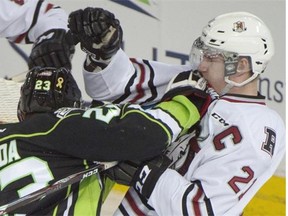 Edgars Kulda of the Edmonton Oil Kings battles with Wyatt Johnson of the Red Deer Rebels during Friday’s Western Hockey League game at Rexall Place.