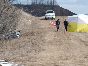 RCMP on the scene were a body was found inside a burned vehicle on a service road just north of Highway 16 and Range Road 15, west of Stony Plain, April 3, 2015.