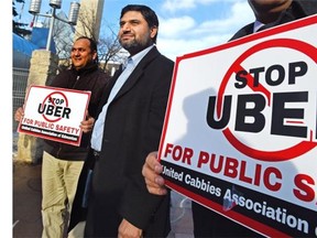 Abouzar Aslam, centre, VP Edmonton Taxis Drivers Association, takes part in an anti-Uber protest at City Hall Jan. 14, 2015.