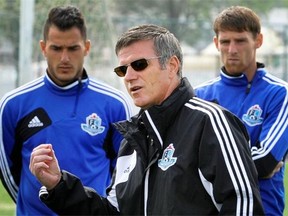 FC Edmonton head coach, Colin Miller speaks to his players during a practice at Clarke Field on Aug. 27, 2013.