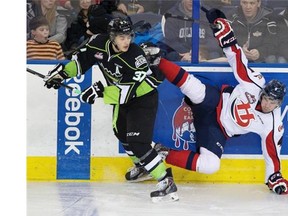 Edmonton Oil Kings’ Dysin Mayo knocks Lethbridge Hurricanes Devan Fafard to the ice during January Western Hockey League action at Rexall Place.