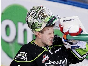 Edmonton Oil Kings rookie goaltender Patrick Dea gives himself a splash that refreshes during a Western Hockey League game against the Lethbridge Hurricanes at Rexall Place on Jan. 2, 2014.