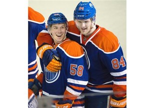 Edmonton Oilers Andrew Miller (58) and Oscar Klefbom (84) celebrate a 4 to 0 win against the Dallas Stars during NHL action at Rexall Place in Edmonton, March 28, 2015. Miller scored his first NHL goal on a penalty shot.