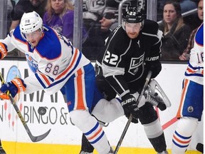 Edmonton Oilers defenceman Brandon Davidson battles with Los Angeles Kings centre Trevor Lewis during Thursday’s NHL game at Los Angeles.