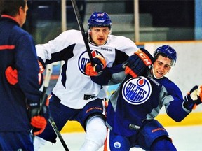 Edmonton Oilers’ first-round draft pick Leon Draisaitl, left, knocks down defenceman Joey Laleggia during the NHL team’s annual prospects development camp on July 3, 2014, at Jasper.