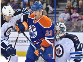 Edmonton Oilers forward Matt Hendricks screens Winnipeg goalie Ondrej Pavelec as the puck hits the Jets’ goalie pads during Monday’s NHL game at Rexall Place.