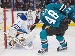 Edmonton Oilers goalie Laurent Brossoit makes a point-blank save on San Jose Sharks forward Tomas Hertl at Rexall Place in Edmonton on April 9, 2015.