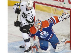 Edmonton Oilers goalie Ben Scrivens tries to move Los Angeles Kings centre Dustin Brown during Tuesday’s NHL game at Rexall Place.