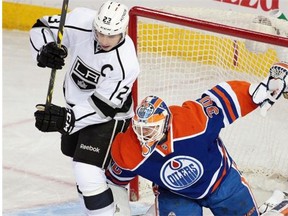 Edmonton Oilers goalie Ben Scrivens tries to move Los Angeles Kings centre Dustin Brown out of his goalcrease during an NHL game at Rexall Place on March 3, 2015.