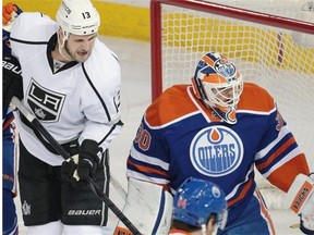 Edmonton Oilers goaltender Ben Scrivens makes a glove save as Los Angeles Kings winger Kyle Clifford looks for a rebound during Tuesday’s National Hockey League game at Rexall Place.