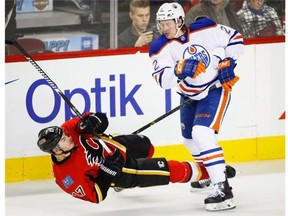 Edmonton Oilers' Jeff Petry, right, sends Calgary Flames' Lance Bouma to the ice during second period NHL hockey action in Calgary on Jan. 31, 2015. The Montreal Canadiens made the first major move on the morning of trade deadline day by acquiring Jeff Petry from the Edmonton Oilers for draft picks. THE CANADIAN PRESS/Jeff McIntosh
