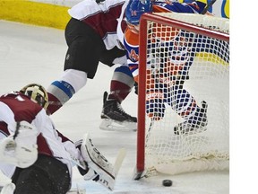 Edmonton Oilers Jordan Eberle (14) scores from behind the net on Colorado Avalanche goalie Semyon Varlamov (1) during NHL action at Rexall Place in Edmonton, March 26, 2015.