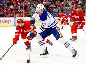 Edmonton Oilers left wing Rob Klinkhammer shoots as Detroit Red Wings defenceman Niklas Kronwall defends in the first period of an NHL hockey game in Detroit on Monday, March 9, 2015.