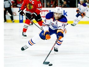 Edmonton Oilers right wing Jordan Eberle (14) advances with the puck against the Chicago Blackhawks during the first period of an NHL hockey game on Sunday, Nov. 10, 2013, in Chicago. (AP Photo/Andrew A. Nelles)