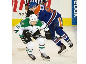 Edmonton Oilers Ryan Nugent-Hopkins (93) gets hooked by Dallas Stars and former Oiler Shawn Horcoff (10) during NHL action at Rexall Place in Edmonton, March 28, 2015.