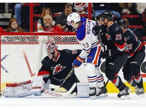 Edmonton Oilers’ Ryan Nugent-Hopkins (93) shoots the puck past Carolina Hurricanes goalie Cam Ward (30) for a goal after skating past Hurricanes’ Riley Nash (20) during the second period of an NHL hockey game in Raleigh, N.C., Sunday, March 8, 2015, in Raleigh, N.C.