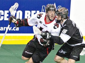 Edmonton Rush Chris Corbeil battles with Vancouver Stealth Tyler Digby during first half action at Rexall Place on March 14, 2015.
