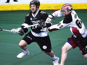 Edmonton Rush forward Mark Matthews uses one arm on his stick and the other on the Colorado Mammoth’s Creighton Reid’s stick while zeroing in on net in National Lacrosse League action at Rexall Place in Edmonton, Feb. 15, 2015.