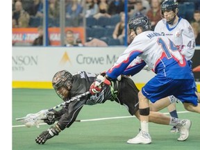 The Edmonton Rush’s Ben McIntosh gets hounded by Rob Marshall of the Toronto Rock during Friday’s National Lacrosse League game at Rexall Place.