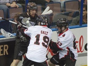 Edmonton Rush rookie Ben McIntosh gets double-teamed by Justin Salt and Brandon Clelland of the Vancouver Stealth during Friday’s National Lacrosse League game at Rexall Place.