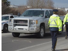 Law enforcement officers from the EPS, RCMP detachments and the province’s commercial vehicle enforcement unit conduct traffic enforcement at Highway 60 and Yellowhead on Friday.