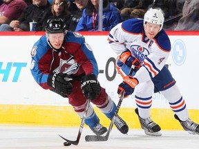 Erik Johnson #6 of the Colorado Avalanche skates against Taylor Hall #4 of the Edmonton Oilers at the Pepsi Center on Jan. 2, 2015, in Denver.