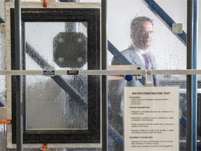 Fabian Joseph, operations manager of Western Canada for the CSA Group, stands behind a testing station in Edmonton where doors and windows are blasted with water. CSA Group, the product-testing organization, is opening an expanded lab that tests window and doors in its new lab.