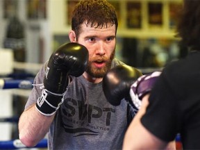 UFC fighter Mitch Clarke sparing with his trainer while training at Edmonton's Frank Lee's Martial Arts Gym on Feb. 4, 2015.