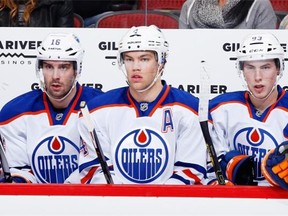 From left to right, Oilers players Teddy Purcell, Taylor Hall and Ryan Nugent-Hopkins sit on the bench during a 2-1 loss to the Arizona Coyotes in Glendale, Arizona, on Dec. 16, 2014. Purcell is one of only 13 players who saw action for the Oilers this season who’ve ever played in the NHL playoffs; his experience came with the Tampa Bay Lightning.
