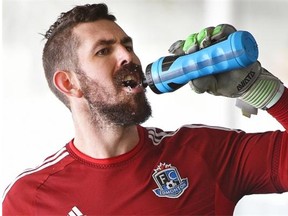 Goal keeper Matt Van Oekel rehydrates at FC Edmonton training camp at Commonwealth Stadium fieldhouse in Edmonton, Feb. 25, 2015.