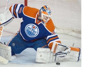 Goalie Ben Scrivens (30) makes a save as the Edmonton Oilers play the Toronto Maple Leafs at Rexall Place in Edmonton on March 16, 2015.