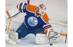 Goalie Ben Scrivens (30) makes a save as the Edmonton Oilers play the Toronto Maple Leafs at Rexall Place in Edmonton on March 16, 2015.