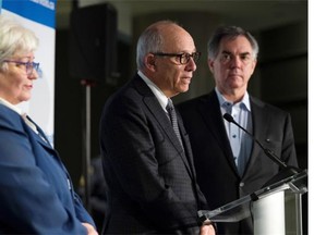 Health Minister Stephen Mandel (centre), Premier Jim Prentice (right), and Vickie Kaminski, Alberta Health Services president and CEO release details about health capital and maintenance funding.