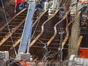 High winds are a possible culprit in the buckling of steel girders on the new 102nd Avenue bridge being built over Groat Road.