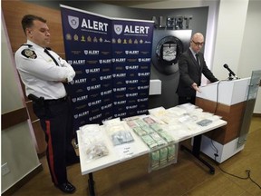 Inspector Darcy Strang, right, and EPS Inspector Darren Derko speak to media about a large fentanyl drug bust at ALERT headquarters in Edmonton on Wednesday March 25, 2015.