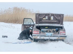 Isaias Morgan tries to dig his vehicle out of a snow bank after losing control near Grouroches River along the winter ice road from Fort McMurray to Fort Chipewyan. The 200-km temporary road typically opens mid-December and closes mid-March, depending on the weather.