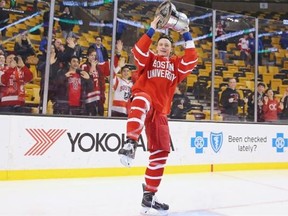 Jack Eichel of the Boston University Terriers celebrates with the Beanpot trophy following the 4-3 win over the Northeastern Huskies during over time at the 2015 Beanpot Tournament Championship game at TD Garden on Feb. 23, 2015, in Boston.