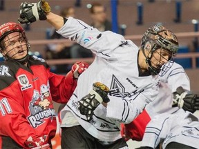 John Lintz of the Edmonton Rush throws a backwards elbow catching Greg Harnett of the Calgary Roughnecks during NLL action on Sunday, March 8, 2015, at Rexall Place in Edmonton. The Roughnecks won the game 12-11 in overtime.